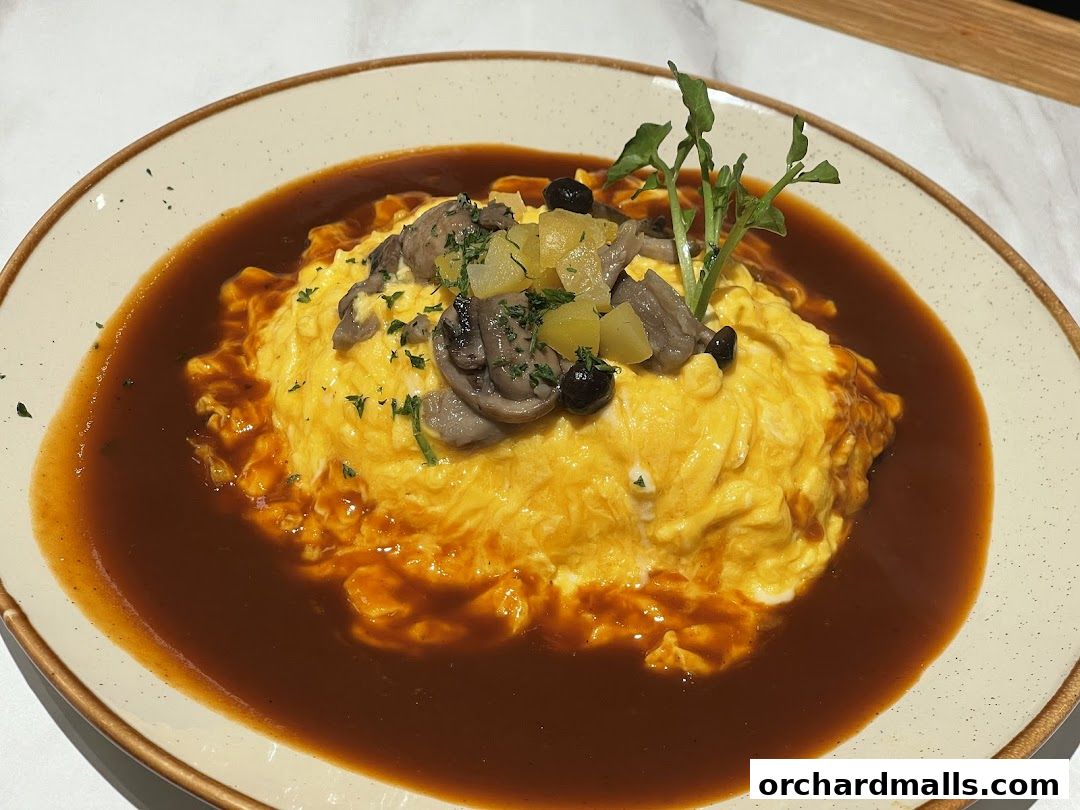 A delicious omurice dish with mushrooms and sauce, beautifully presented.