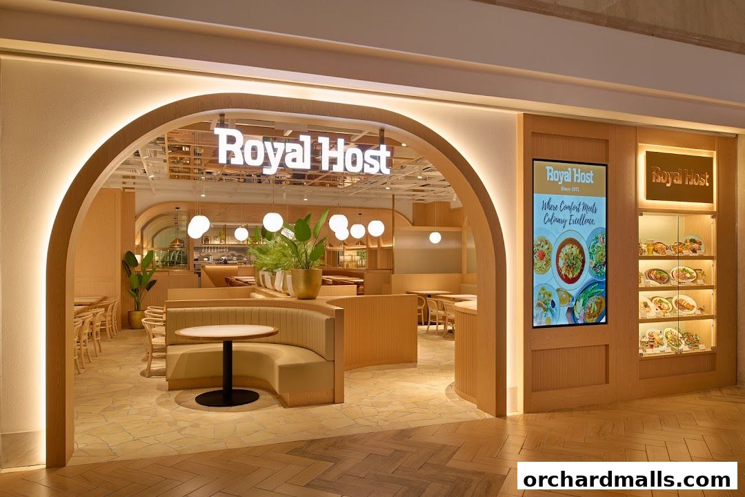 The inviting entrance of Royal Host restaurant with a digital menu and display of food.