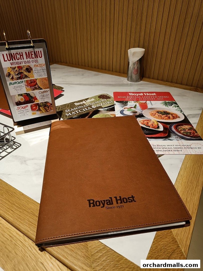 A table setting with a Royal Host menu and lunch specials displayed.