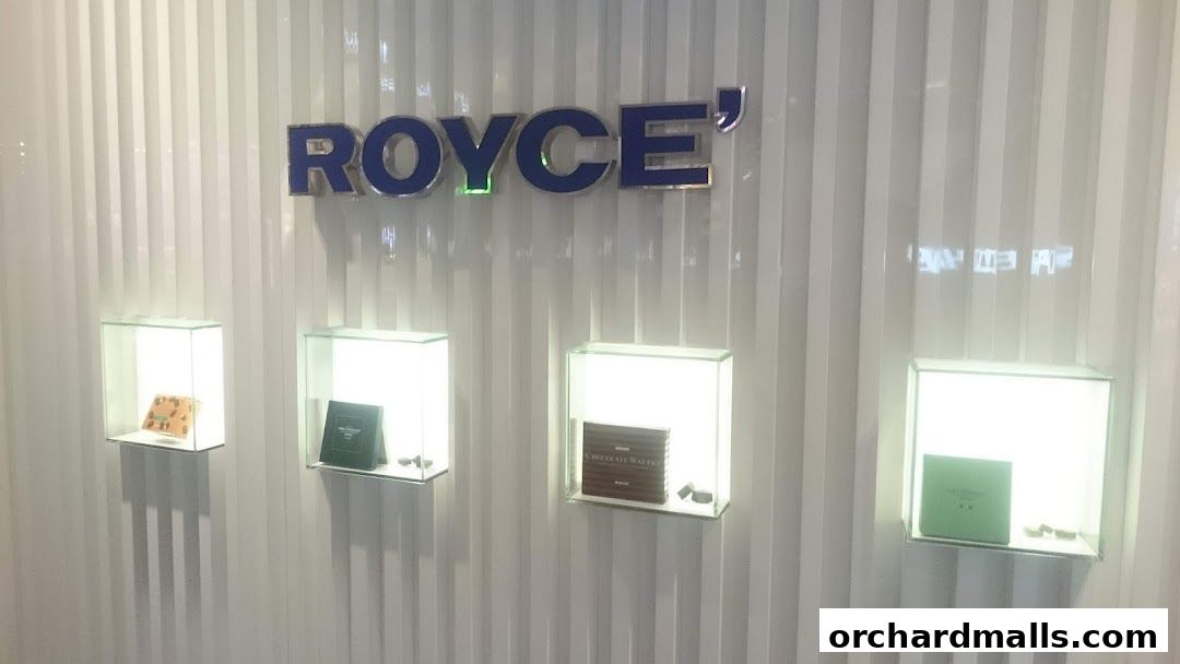 Royce shop interior with illuminated display cases showcasing chocolates and wafers.