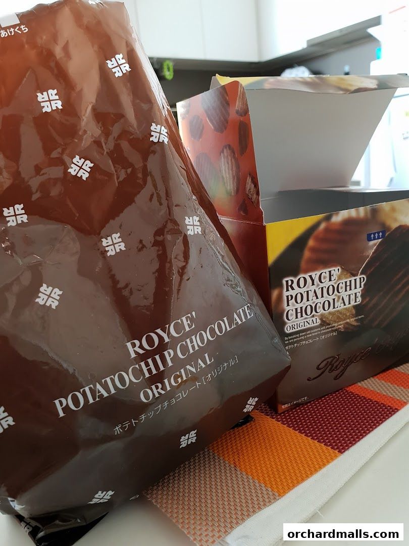 A close-up of Royce Potato Chip Chocolate Original packaging and a large bag.