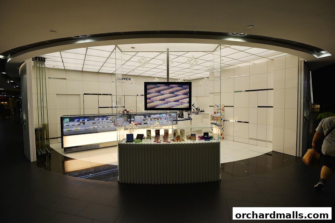 The Royce shop features a modern, clean design with glass display cases showcasing products.
