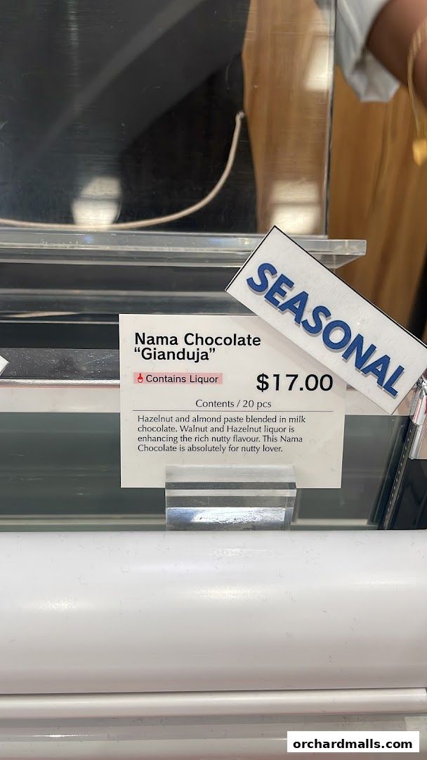 A sign displays Nama Chocolate "Gianduja" with a price and description.