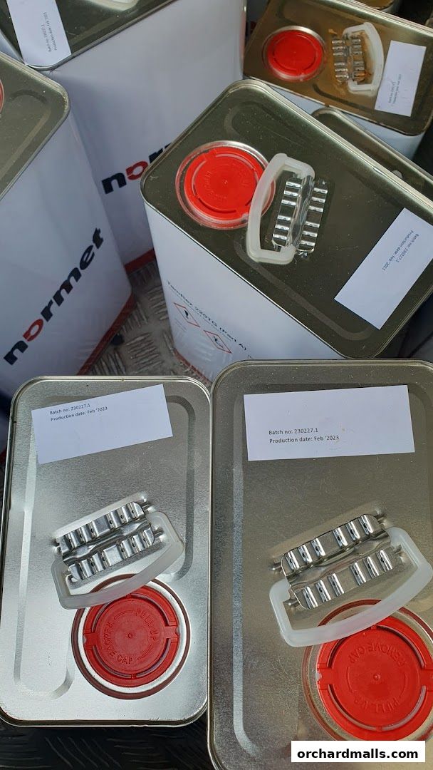 Several metal cans with red caps and handles, labeled 'normet'.