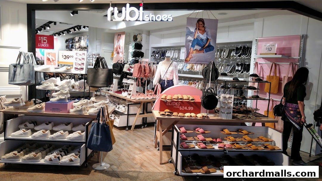 A well-lit shoe store interior showcasing a variety of footwear and bags.