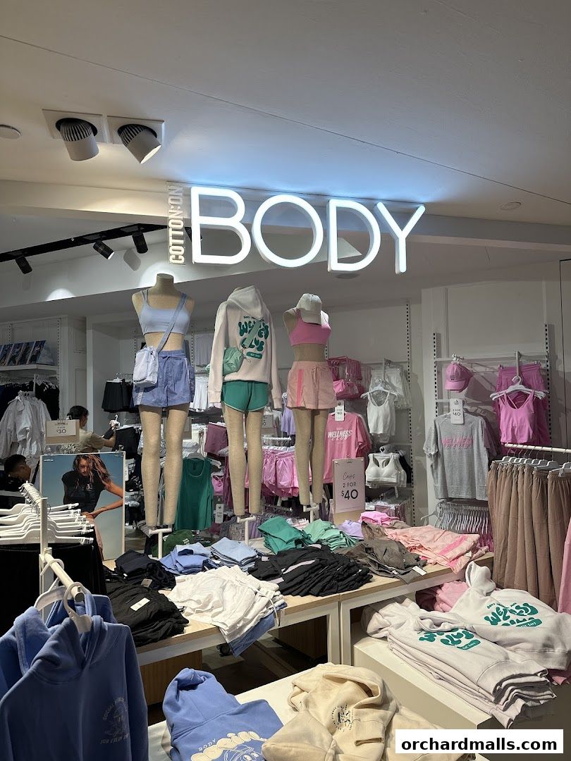 Interior view of Rubi Shoes store showcasing apparel on mannequins and display tables.