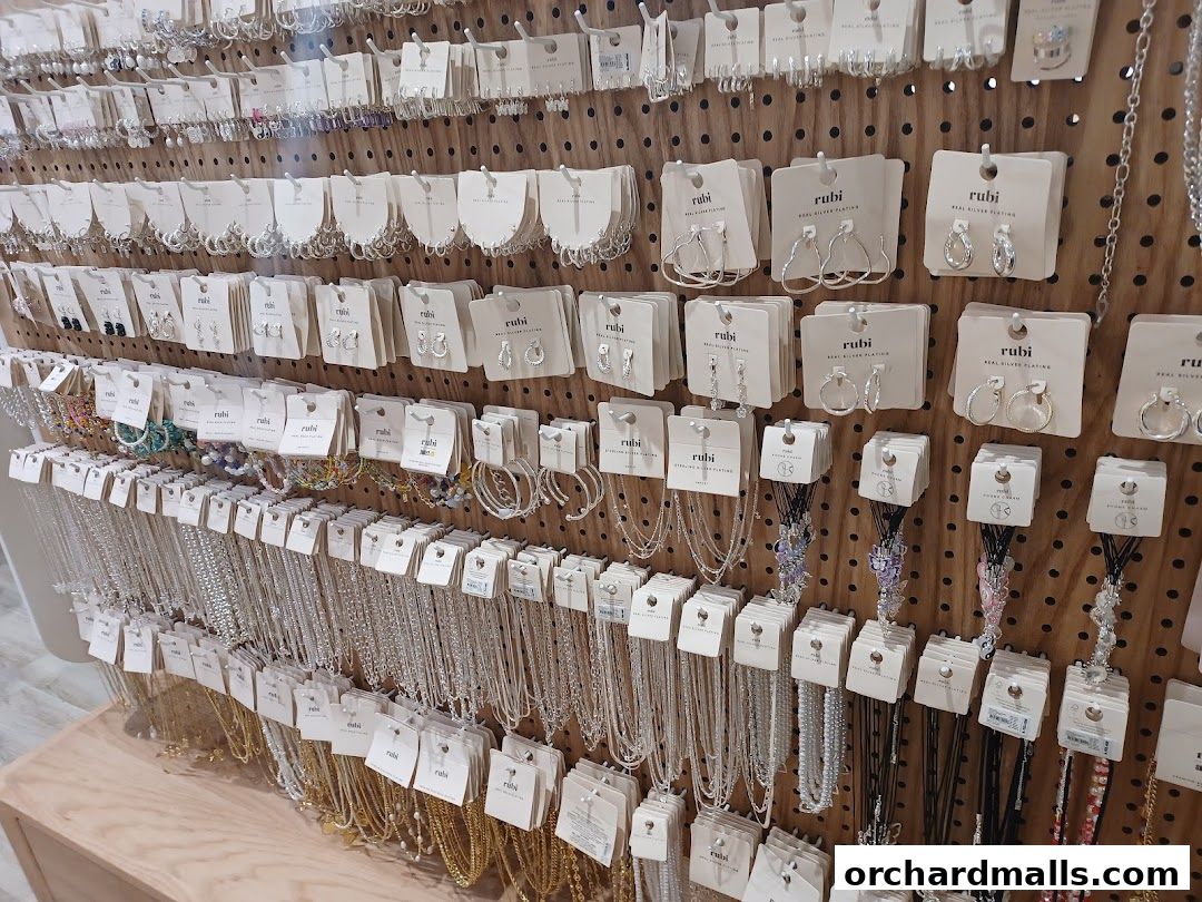 A wall display showcasing a wide variety of Rubi Shoes jewelry, including earrings and necklaces.