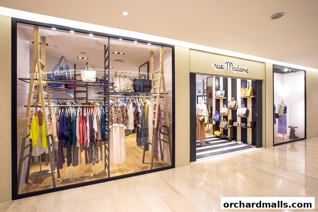 Rue Madame shop front displaying fashionable clothing and handbags in a well-lit display window.