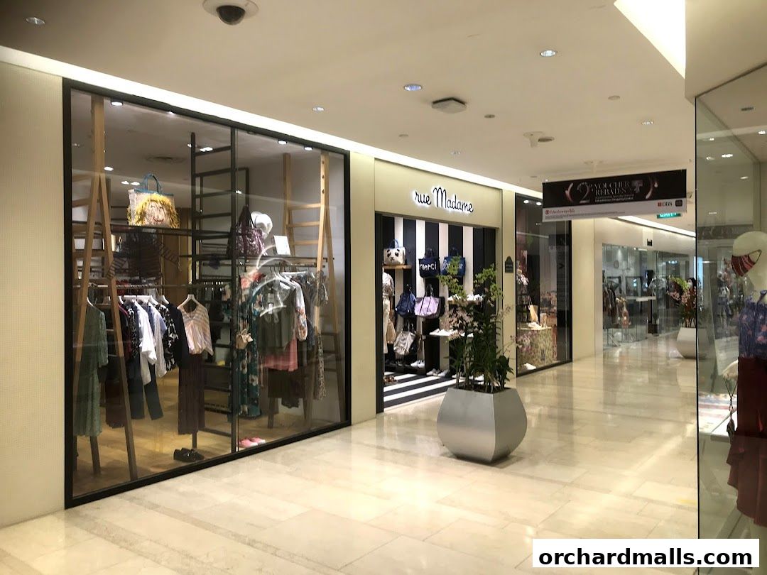 The Rue Madame shop front displays fashionable clothing and accessories in a well-lit mall interior.