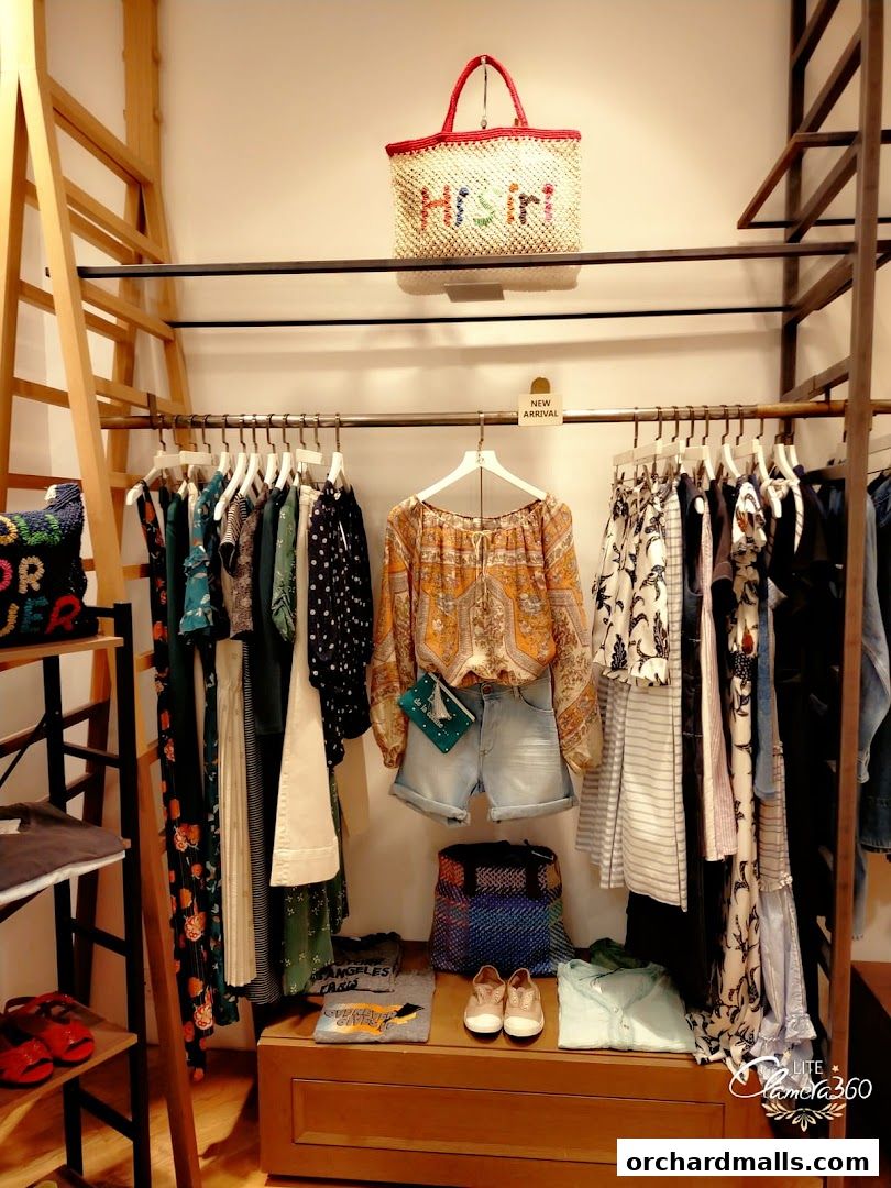 A display of women's clothing and accessories in a boutique setting.