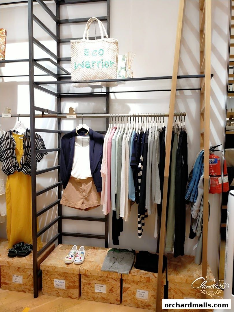 Interior view of Rue Madame clothing store with apparel and accessories displayed.