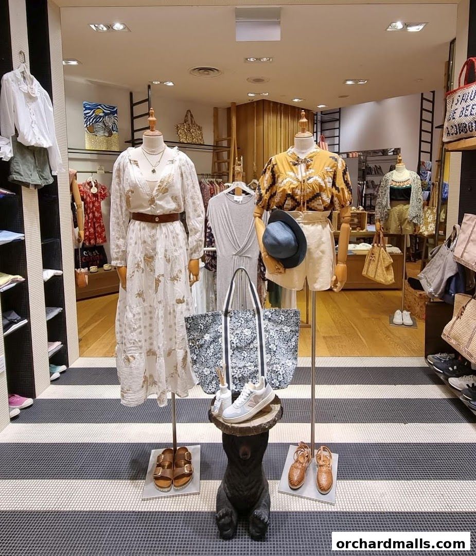 A boutique display featuring mannequins dressed in stylish summer clothing and accessories.