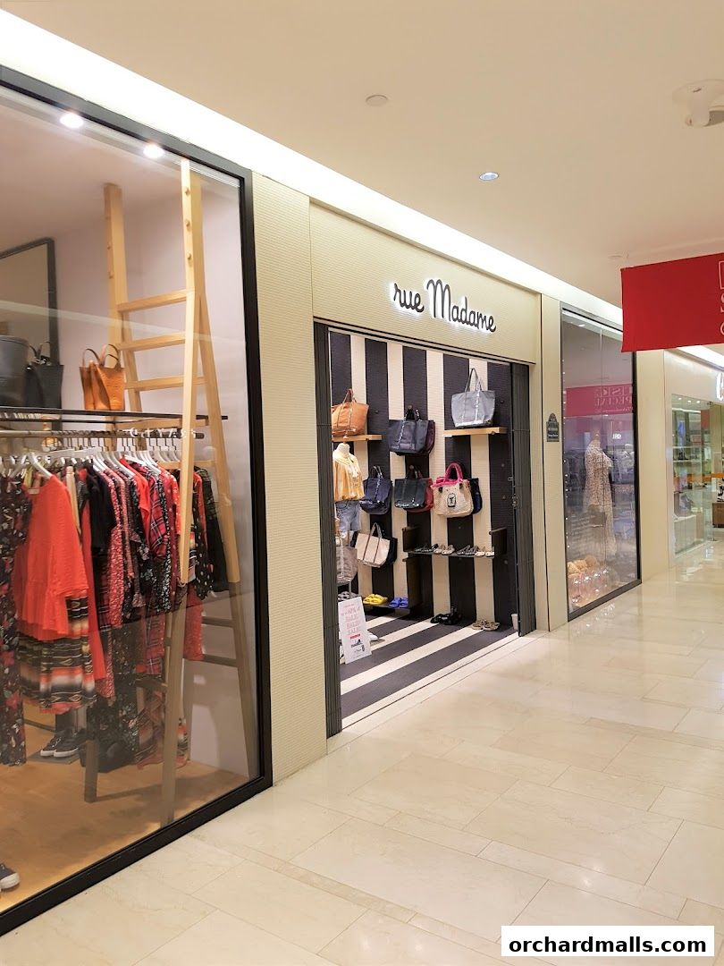 Rue Madame shop front displaying fashionable clothing and handbags in a mall.