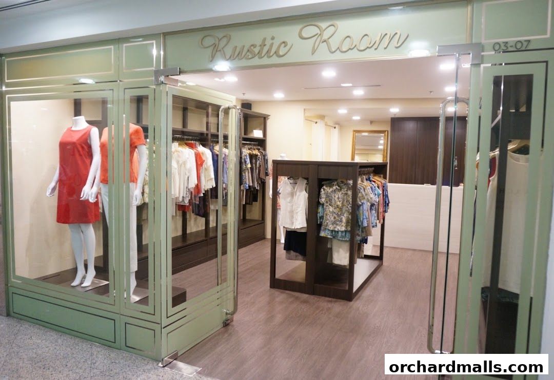 The entrance of a clothing store named Rustic Room, showcasing mannequins and apparel.