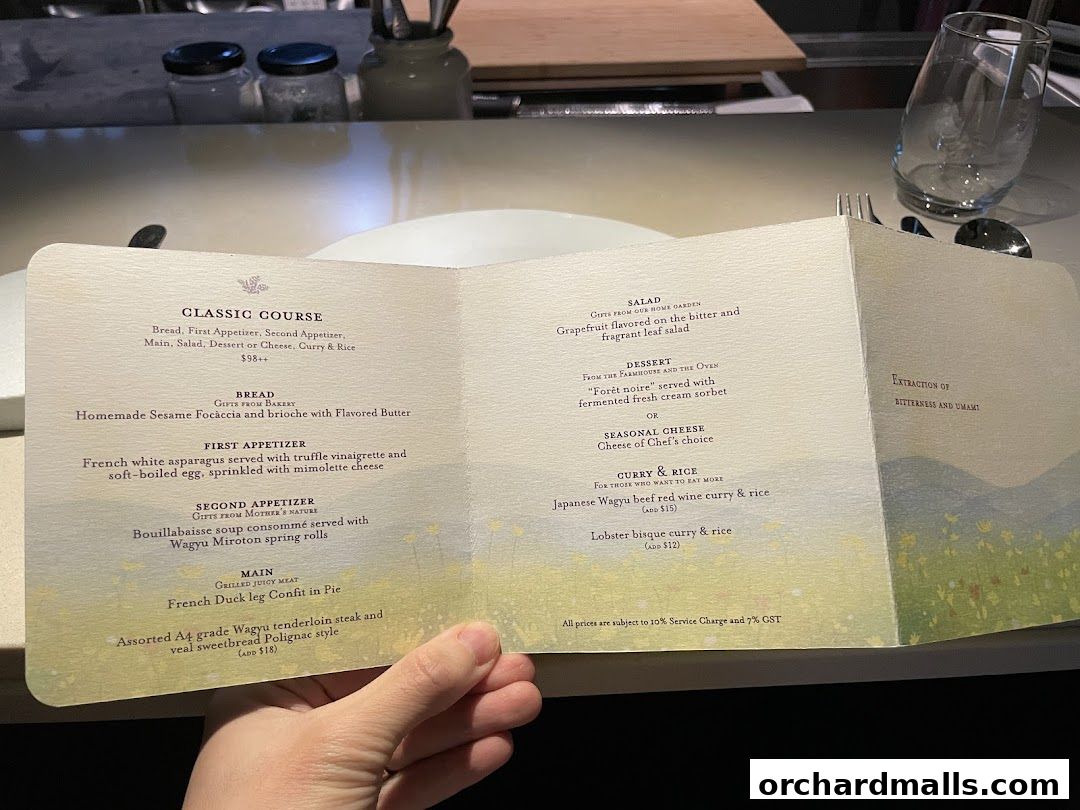 A person holding an open menu for Sage by Yasunori Doi, detailing a classic course meal.