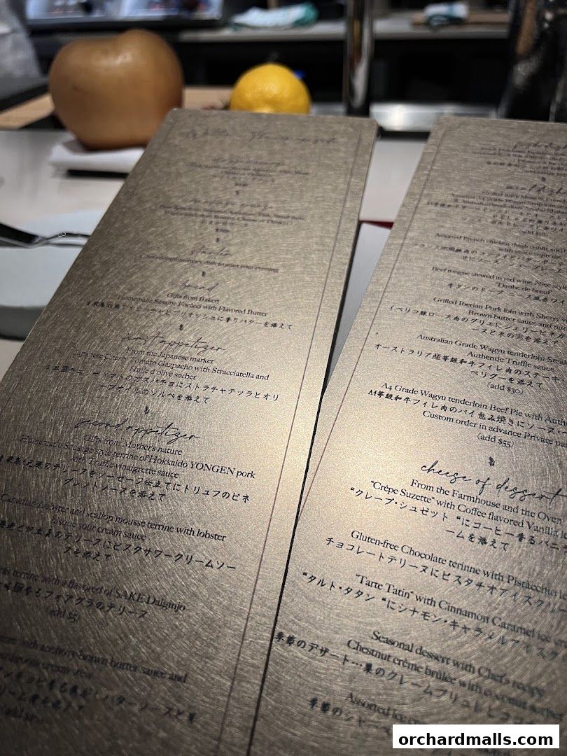 A close-up view of two elegant menus with gold lettering, displaying food and dessert options.