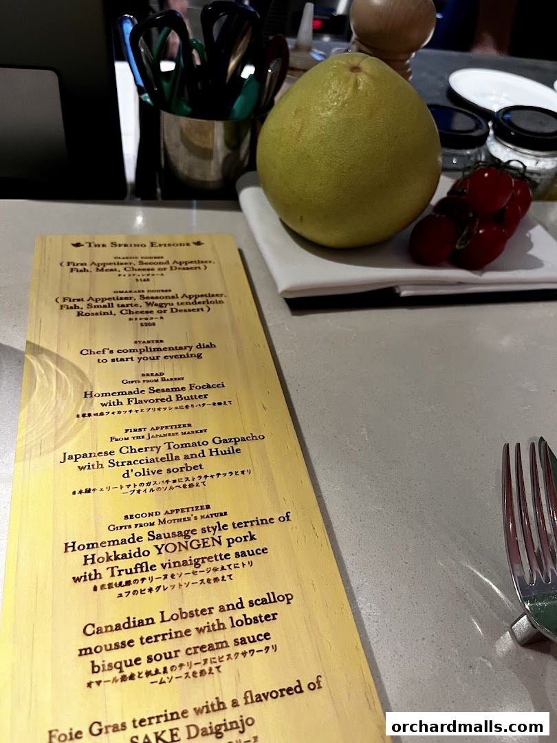 A wooden menu with a tasting course titled 'The Spring Episode' and various dishes.