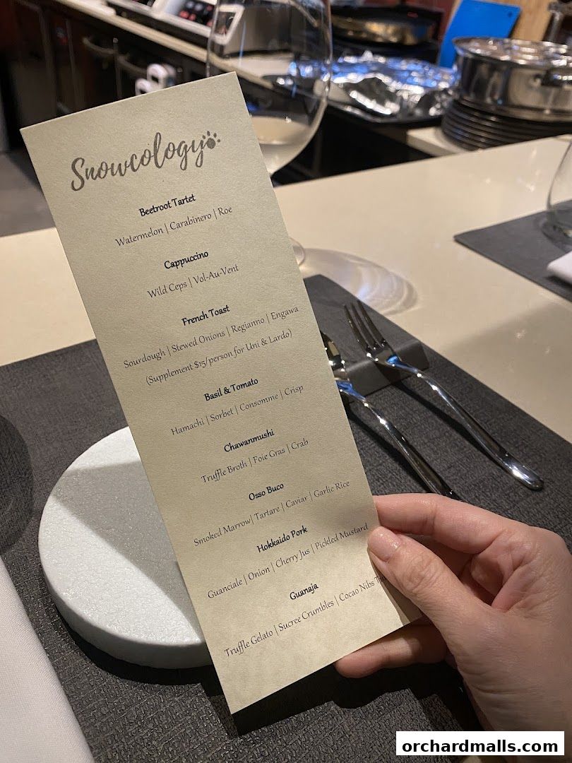 A menu from Snowcology by Yasunori Doi with various dishes listed.