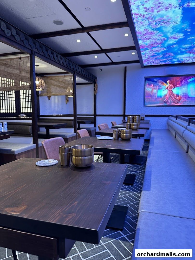 Interior view of a Korean restaurant with wooden tables and modern seating.