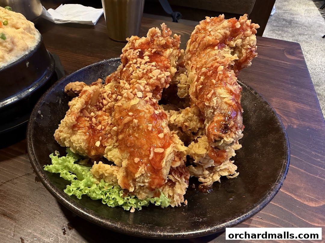 Crispy Korean fried chicken with sweet and spicy sauce and crushed peanuts.