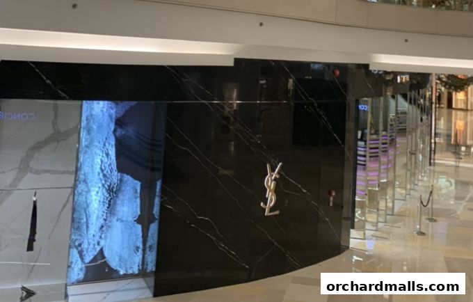 The Saint Laurent shop front features a sleek black marble facade with the iconic YSL logo.