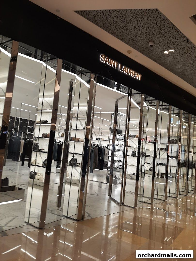 The Saint Laurent shop front features a sleek, modern design with mirrored pillars and a well-lit interior displaying merchandise.