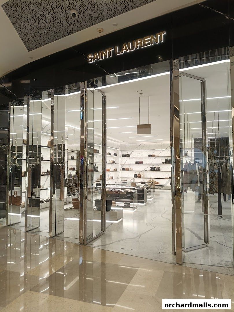 The elegant entrance of a Saint Laurent boutique, showcasing luxury handbags and apparel.