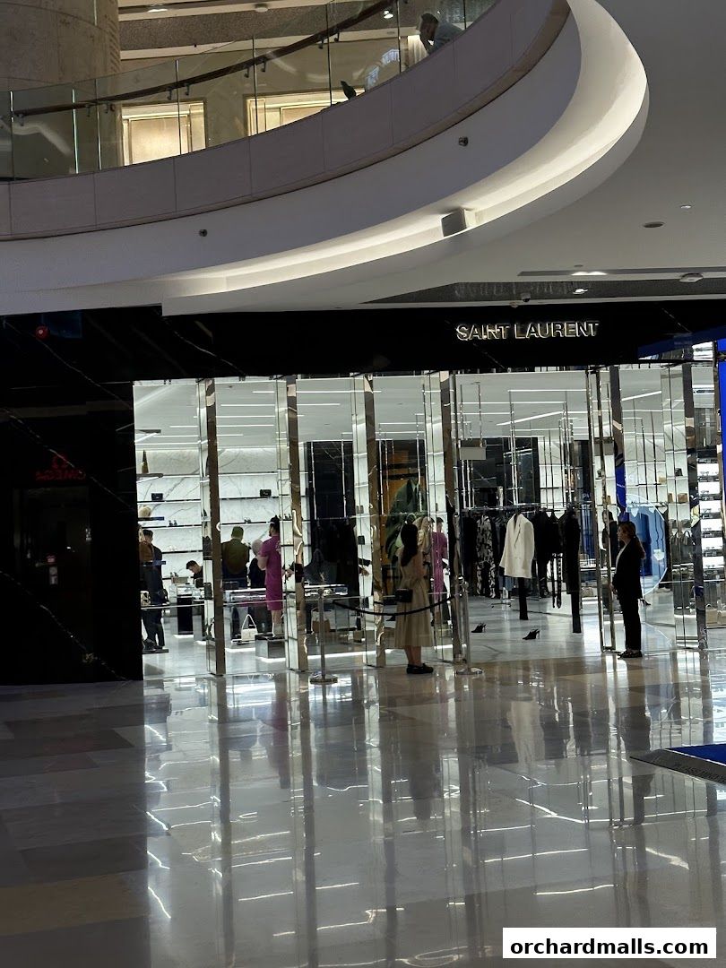 The Saint Laurent store entrance with mannequins and clothing displayed inside.
