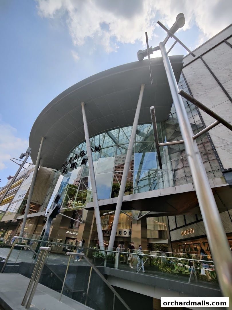 Exterior view of Salvatore Ferragamo and other luxury shops in a modern mall.