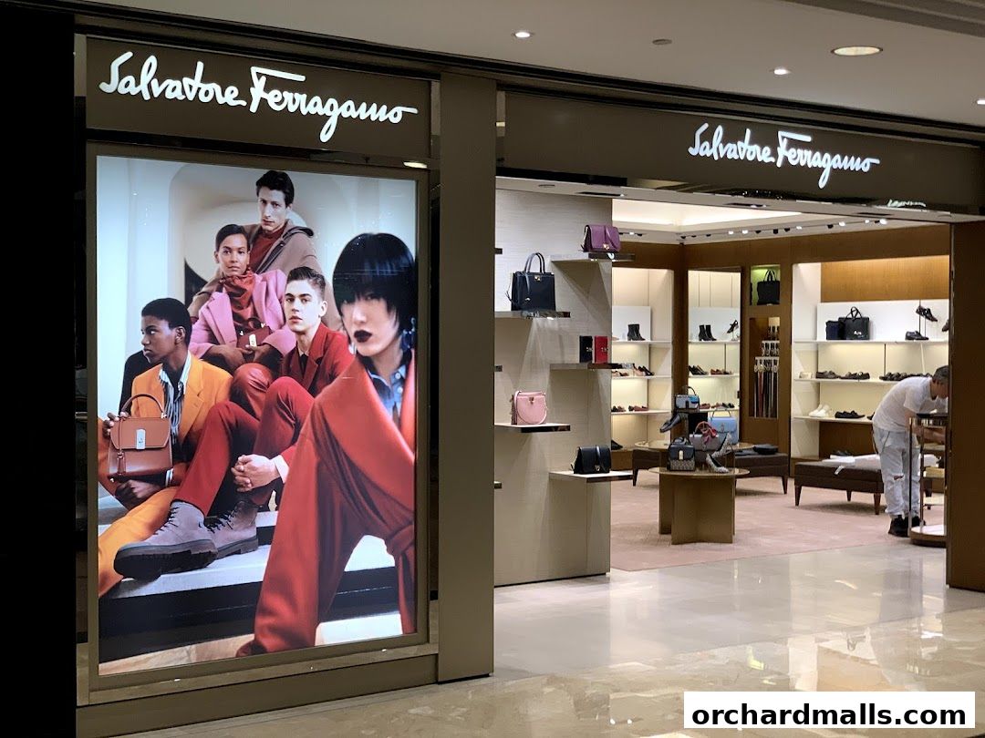 Salvatore Ferragamo shop front with a large advertisement and display of handbags and shoes.