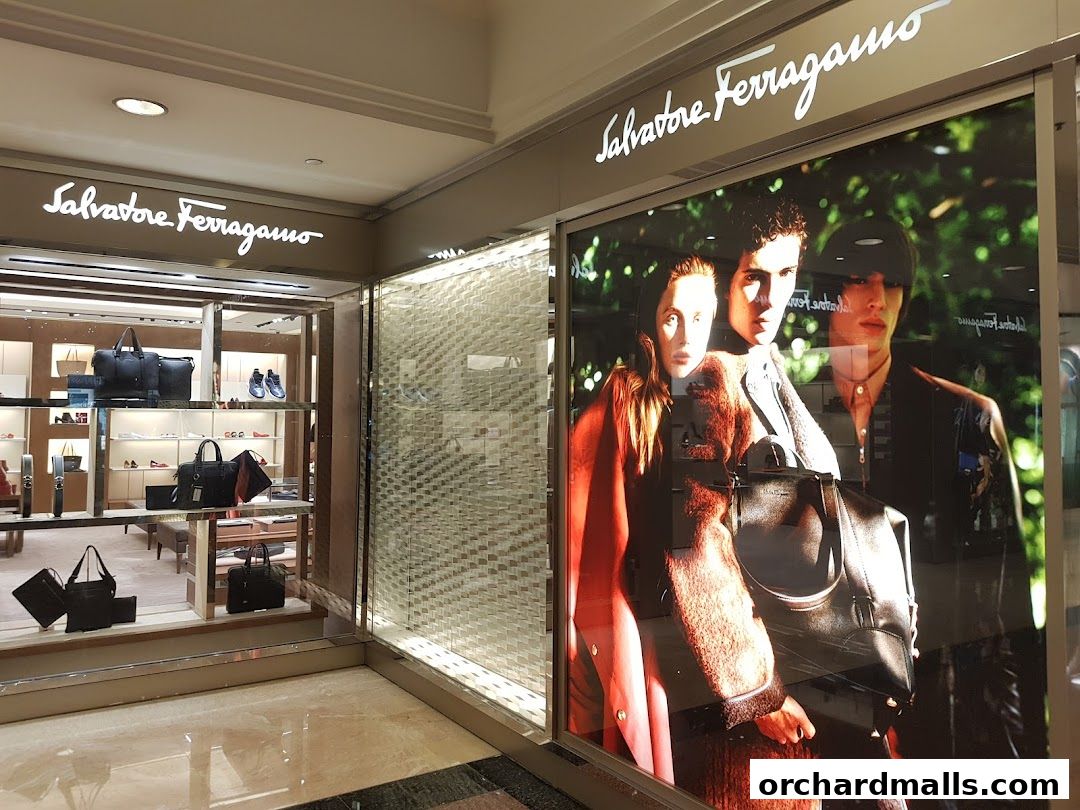 Salvatore Ferragamo shop window display featuring handbags and a fashion advertisement.