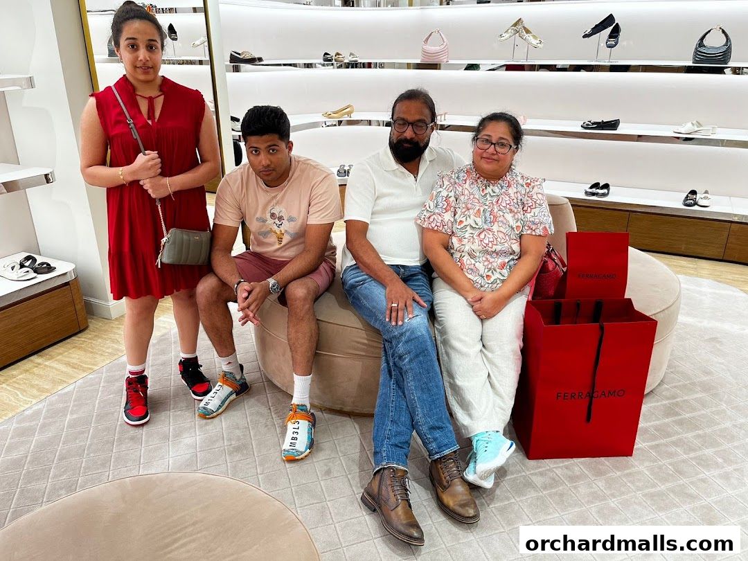 A family poses in a Salvatore Ferragamo store with shopping bags.