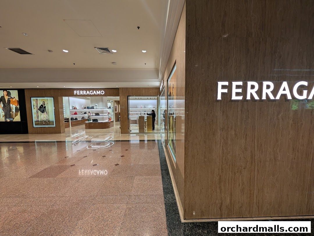 The exterior of a Salvatore Ferragamo store with displays of handbags and shoes.