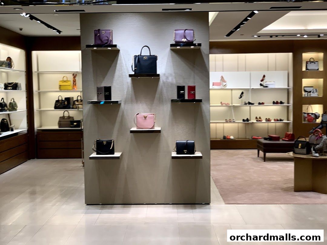 Interior view of a Salvatore Ferragamo store showcasing handbags and shoes on display shelves.