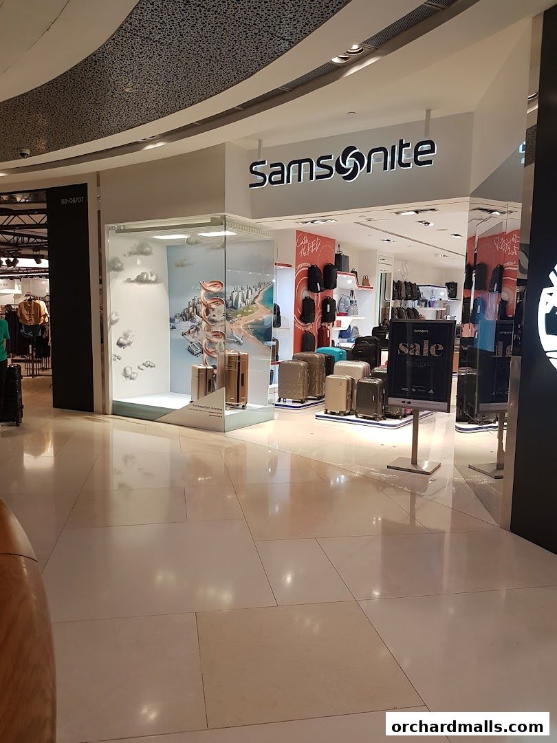 The Samsonite store at ION Orchard showcases luggage and bags with a travel-themed window display.