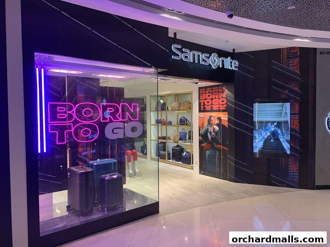 Samsonite store front with luggage displays and neon signage.