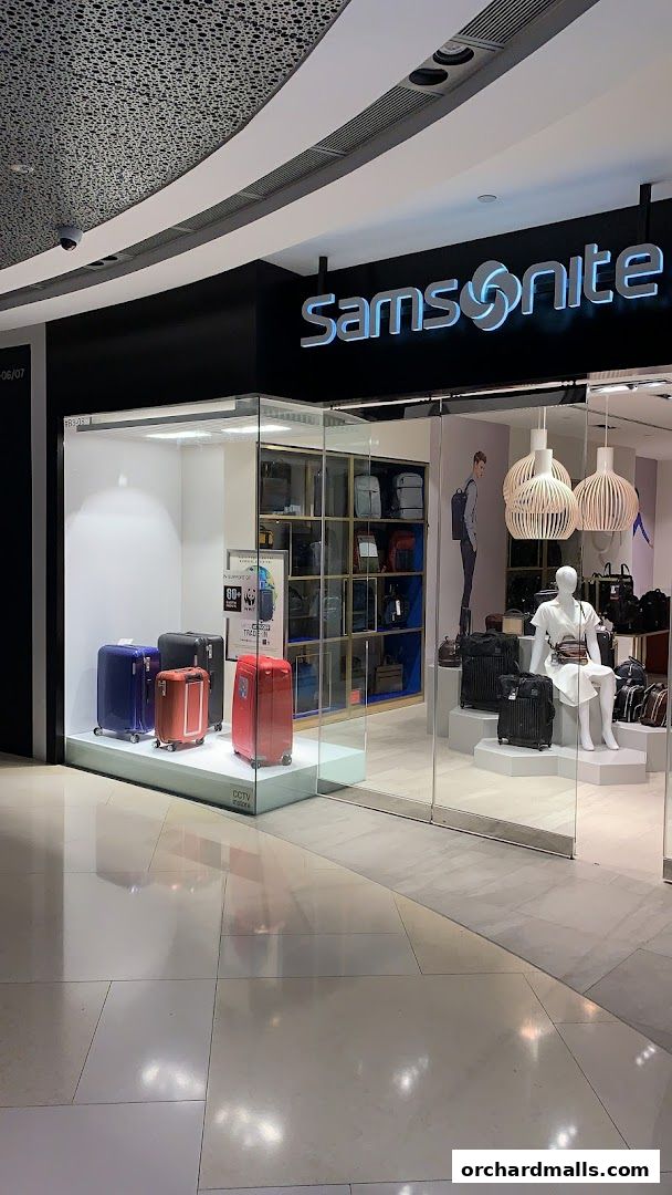 The Samsonite store features a modern glass facade displaying various luggage and bags.