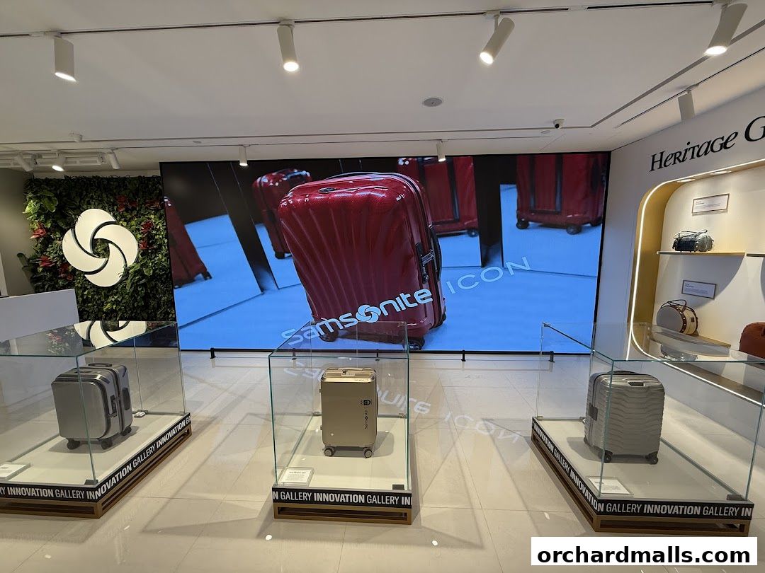 Samsonite store interior showcasing luggage displays and a large screen with brand advertising.
