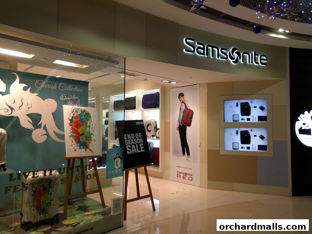 Samsonite store front with luggage displays, artwork, and promotional signage.