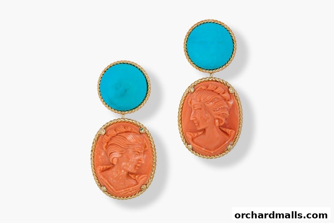 A pair of exquisite coral cameo and turquoise drop earrings with gold detailing.
