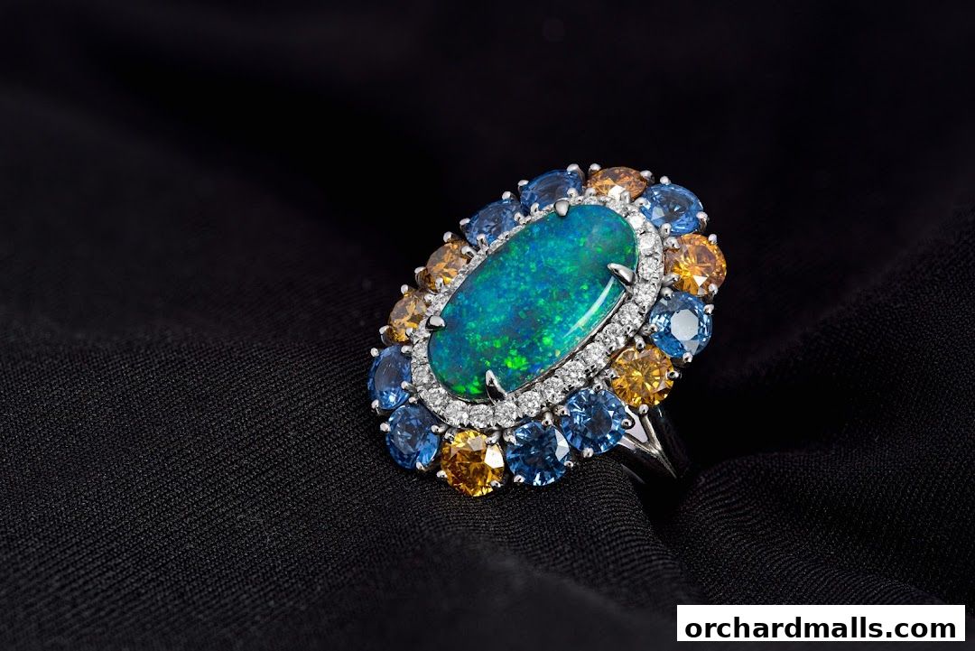A stunning opal and sapphire ring with diamond accents on a black fabric background.