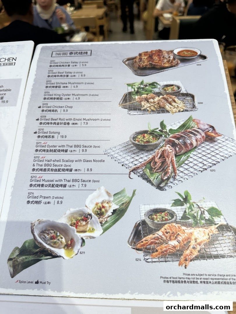 A menu page from Sanook Kitchen featuring Thai BBQ dishes with vibrant food photography.