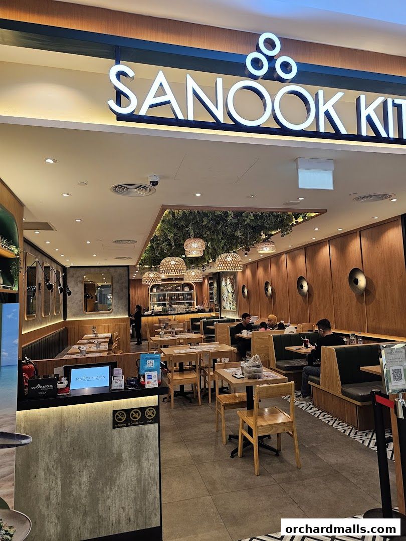 The inviting entrance of Sanook Kitchen Thai BBQ Seafood at ION Orchard, showcasing its warm interior.