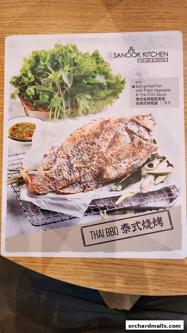 A menu featuring a salt-grilled fish dish with fresh vegetables and chili sauce.