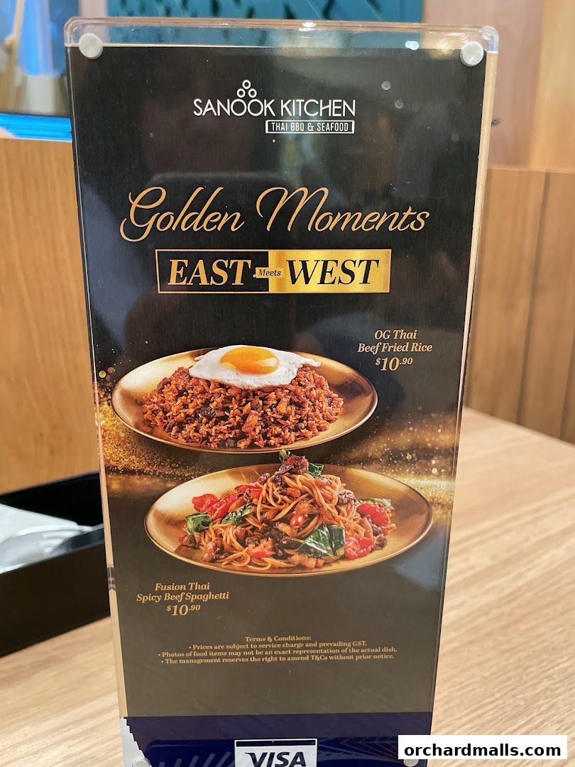 A menu from Sanook Kitchen featuring Thai BBQ and Seafood, highlighting East meets West dishes.