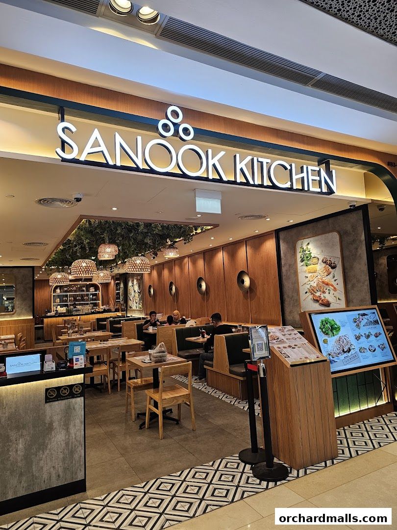 The inviting entrance of Sanook Kitchen Thai BBQ Seafood at ION Orchard, showcasing its warm interior and menu display.