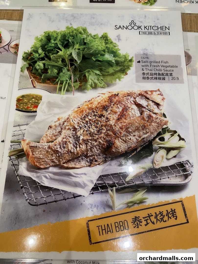 A menu item featuring a salt-grilled fish with fresh vegetables and Thai chili sauce.