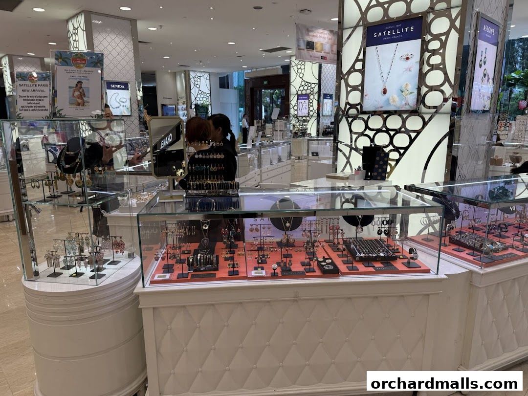 A jewelry store display featuring necklaces, earrings, and bracelets in glass cases.