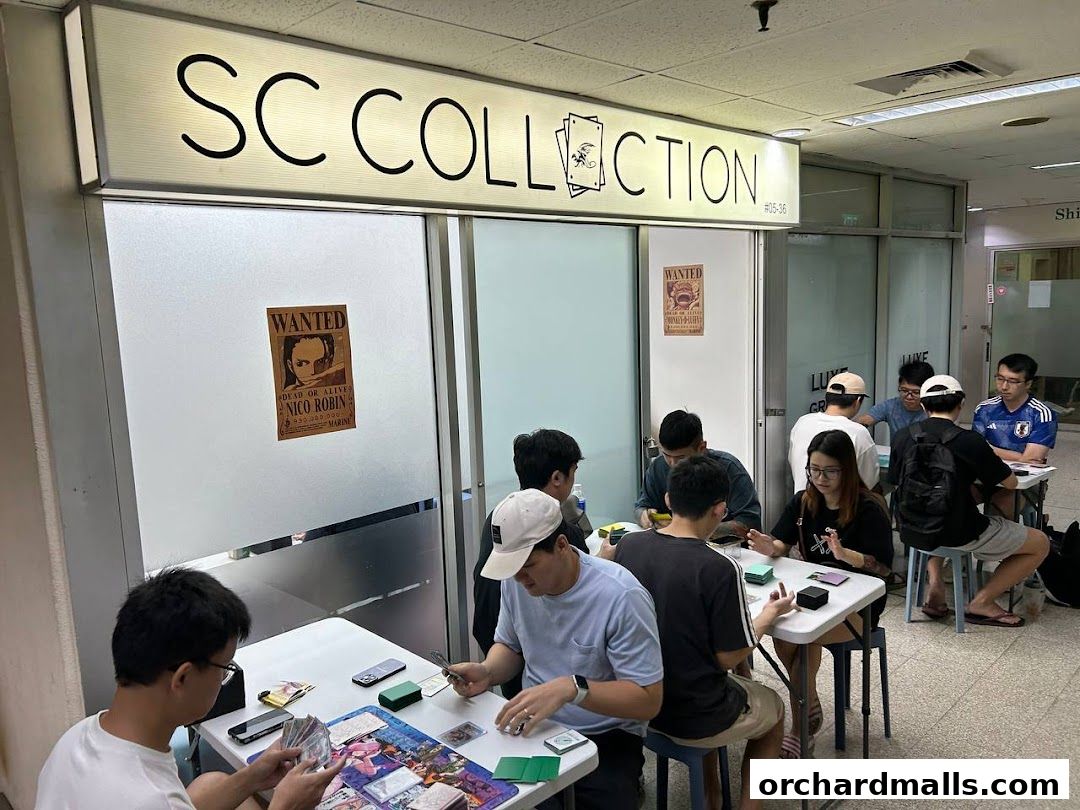 People playing card games at tables inside SC Collection.