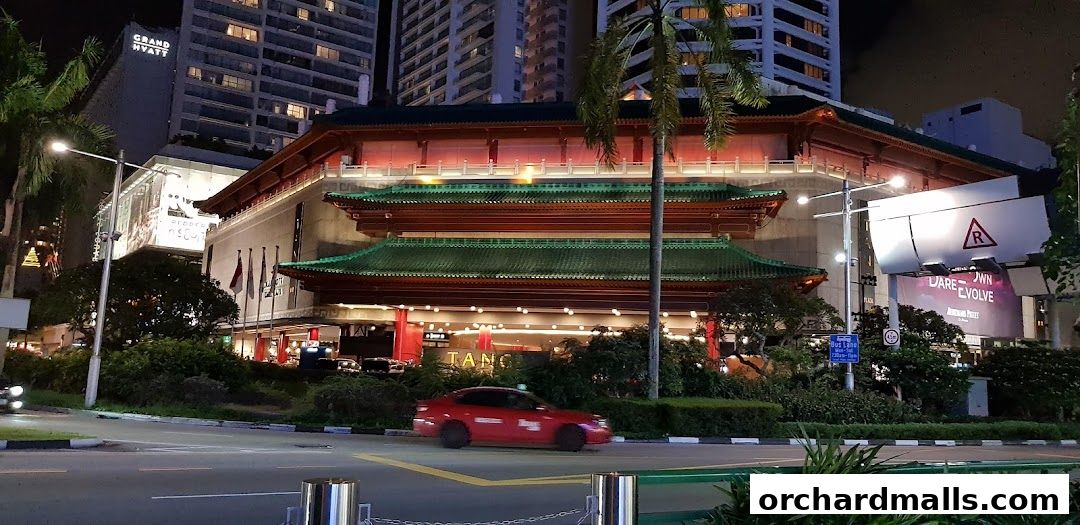 A striking building with traditional East Asian architecture at night, illuminated with warm lights.